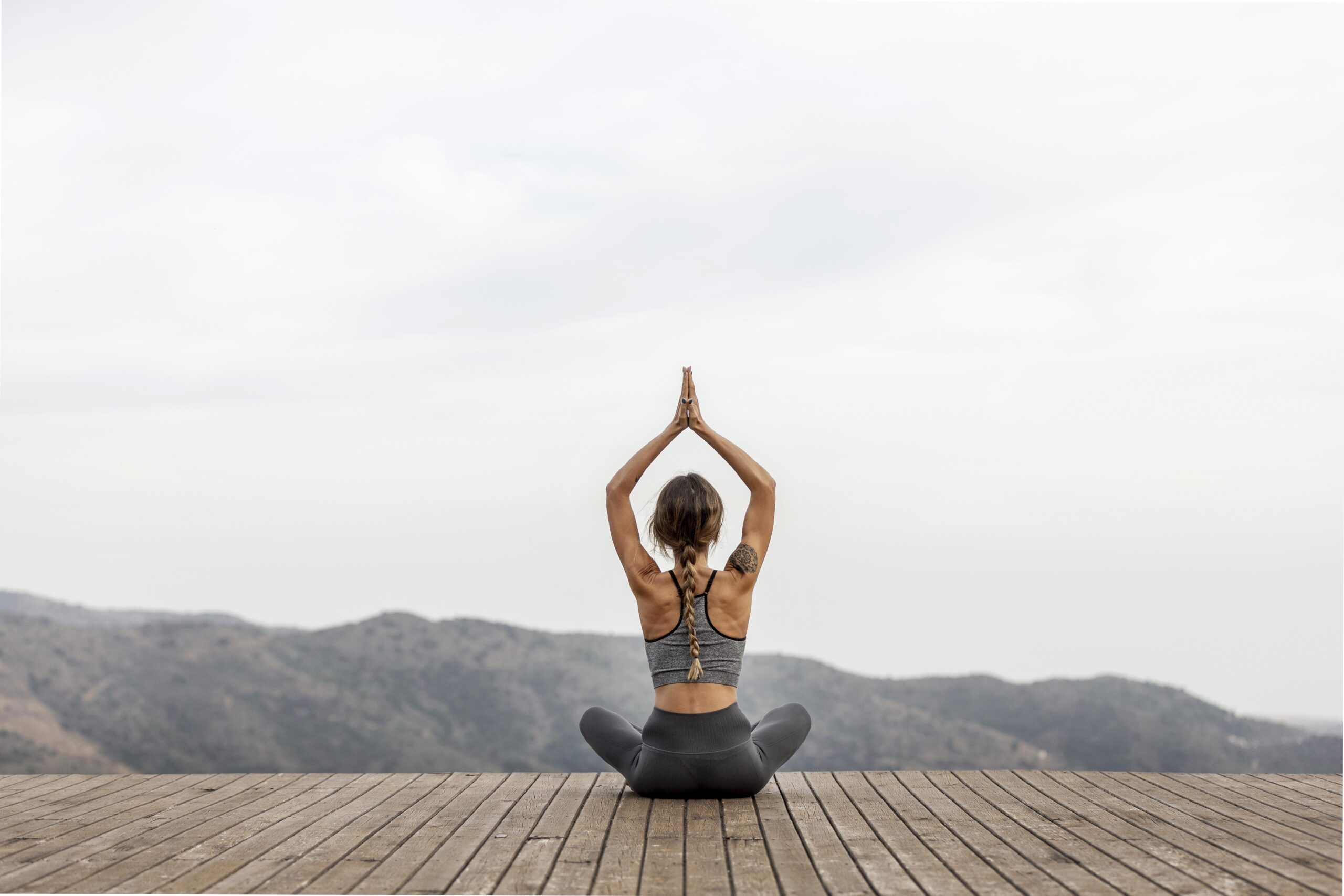 Freepik – back-view-of-woman-doing-yoga-outdoors