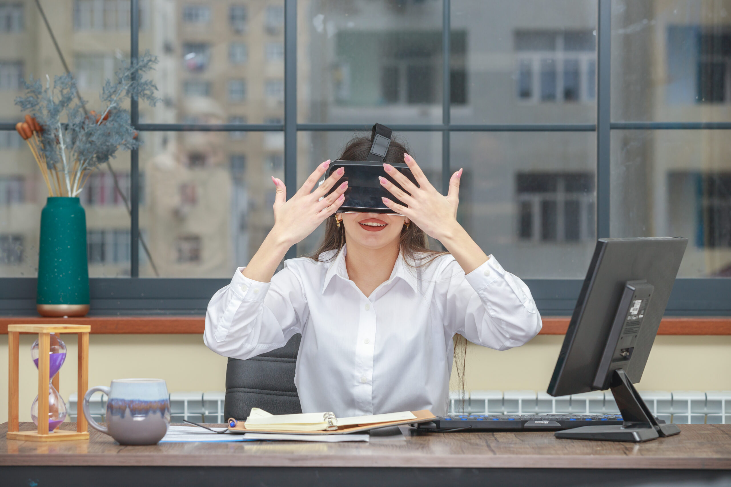 Photo of young lady wearing VR glasses and raised her hands